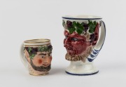 Two antique English and Scottish porcelain Bacchanalian mask head mugs, 18th and 19th century, the smaller with crown mark for Derby, 9.5cm and 16cm high