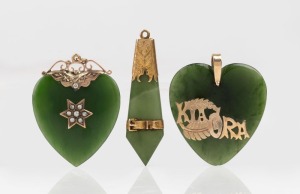 An antique 9ct yellow gold mounted New Zealand greenstone heart shaped pendant adorned with seed pearls, a heart shaped "KIA ORA" greenstone and gold pendant, and a 9ct yellow gold mounted pendant with belt buckle decoration, 19th century, (3 items), the largest 5cm high