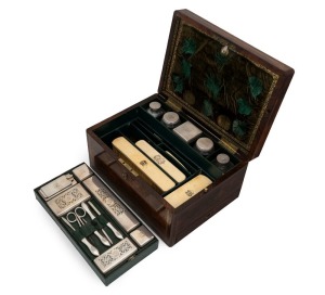 An antique English rosewood travelling box, handsomely fitted with lift-out tray and sterling silver crystal accessories, by William Neal of London, circa 1835, 18cm high, 32cm wide, 23cm deep