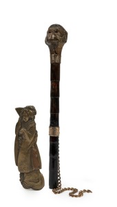 An antique parasol handle with monkey head; together with an antique Japanese page turner handle in the form of a Geisha, 19th century, (2 items), 21cm and 11cm high