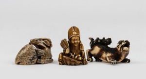 Three Japanese carved ivory and bone netsukes comprising or a seated figure, antelope and a lion, the seated figure 4cm high