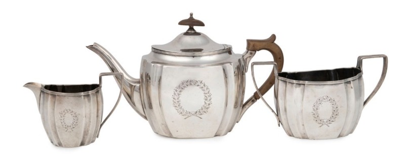 An antique three piece sterling silver tea service by Elkington & Co. of Birmingham, circa 1913, 16cm high, 846 grams total including fruit wood handle and finial