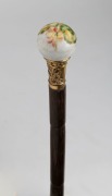 An antique walking stick with French white glass and enamel decorated handle, gold plated collar, palm wood shaft and brass ferrule, 19th century, 72cm high - 2