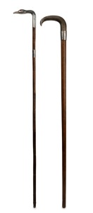 Two antique walking sticks, one silver horn handle and engraved silver collar on an oak shaft, (missing ferrule); the other with a sterling silver swan head handle with glass eyes, sterling silver collar, palm wood shaft and brass ferrule, 19th/20th centu