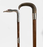 Two antique walking sticks, one silver horn handle and engraved silver collar on an oak shaft, (missing ferrule); the other with a sterling silver swan head handle with glass eyes, sterling silver collar, palm wood shaft and brass ferrule, 19th/20th centu - 2