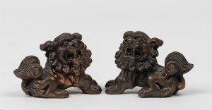 A pair of Chinese cast bronze miniature temple dog ornaments, 20th century, 5.5cm long