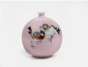 A Japanese spherical pink glazed porcelain vase with hand-painted enamel bird decoration, 20th century, two character mark to base, ​​​​​​​10cm high