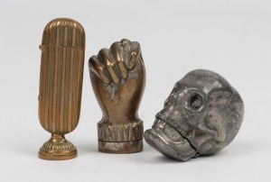 Three assorted novelty vestas comprising a fist, a wax seal, and a skull, 19th/20th century, the largest 6.5cm high