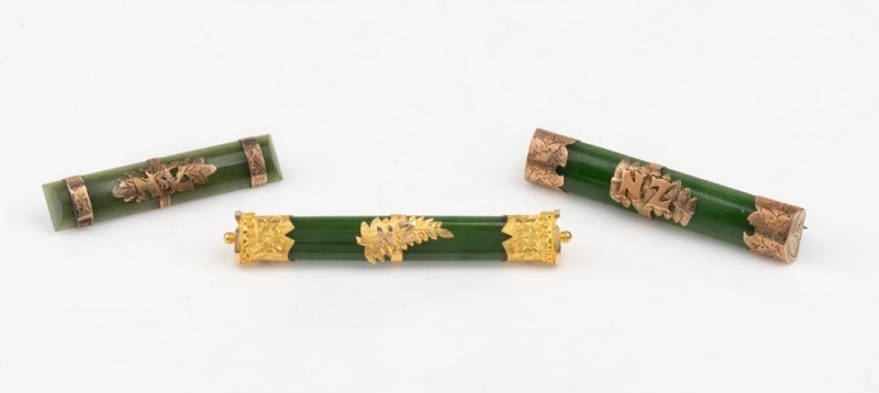 Three antique New Zealand greenstone bar brooches mounted in 15ct and 9ct gold, all emblazoned "N.Z.", 19th century, ​​​​​​​the largest 6.7cm wide