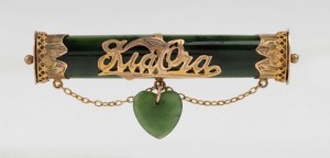 An antique New Zealand greenstone and 9ct gold "KIA ORA" brooch with heart drop, 19th century, 6cm wide