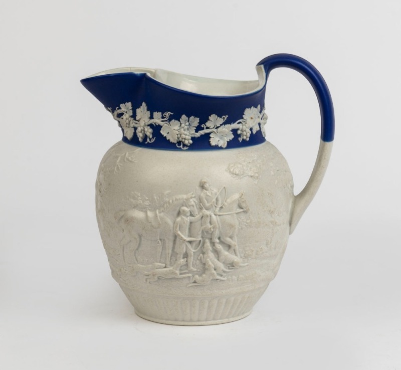 An antique English hunting scene pottery jug with blue and white Jasper Ware border, circa 1820, 20cm high