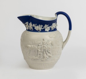 An antique English hunting scene pottery jug with blue and white Jasper Ware border, circa 1820, 20cm high