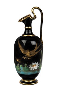 An antique English Aesthetic Movement black porcelain ewer with enamel lily pond scene, decorated with bird and insects in gilded highlights, 19th century, 30.5cm high