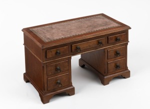 A vintage jewellery box in the form of a miniature twin pedestal desk with embossed tooled brown leather top, early to mid 20th century, 19cm high, 31cm wide, 17cm deep