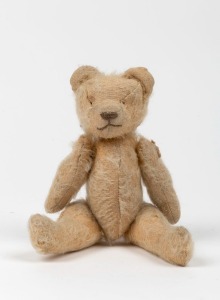 An antique straw filled teddy bear, most likely English, circa 1920s, 20cm high