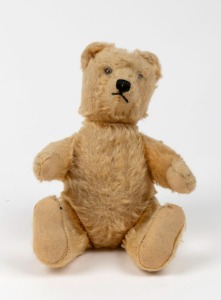 A vintage English straw filled teddy bear, mid 20th century, 24cm high