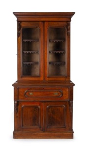 An antique Australian cedar secretaire bookcase with carved corbels, interior fitted with compartments and drawers in huon pine, circa 1880, 136cm high, 114cm wide, 56cm deep