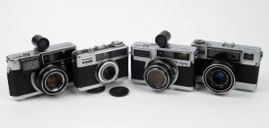 FUJI OPTICAL: Four c. 1960s rangefinder cameras - one Fujica Auto-M, one Fujica 35-EE with 7.5cm Tele Finder, one Fujica 35-SE also with 7.5cm Tele Finder, and one Fujica Drive with lens cap. (4 cameras)