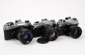 FUJI OPTICAL: Three c. 1970s SLR cameras - one Fujica AZ-1, one Fujica ST-701, and one Fujica AX-3 with front lens cap. (3 cameras)