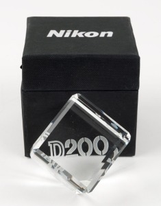 NIPPON KOGAKU: 5 x 5 x 5cm crystal cube with bevelled edges and frosted inscriptions that read 'Nikon D200 DSLR', in maker's cloth-lined box.