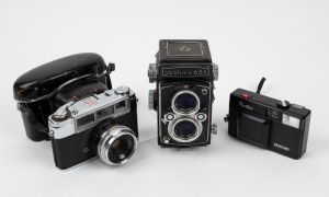 YASHICA: Group of three cameras - one c. 1958 Yashica 635, one c. 1962 Yashica Minister II with leather case, and one c. 1983 Yashica Partner. (3 cameras)