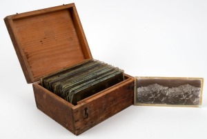 Group of twenty-three 17 x 8.5cm stereo glass slides, c. 1859, featuring family gatherings, homesteads, and landscapes, all organised into wooden box. (23 items)