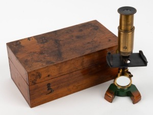 19th-century brass and steel microscope with orange and green painted base, 17 cm at highest setting, in timber box.