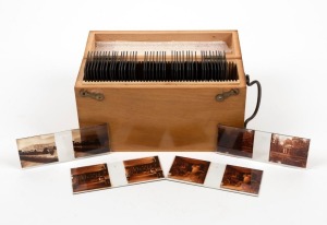 Forty-seven 10.5 x 4.5cm stereoscopic glass slides featuring interiors and exteriors of the Palace of Versailles and surrounding structures, in timber box with metal handle.