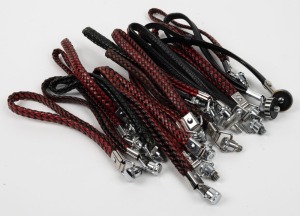 BOLEX-PAILLARD: Nineteen 8mm movie camera wrist straps, mostly black/red woven leather. (19 items)