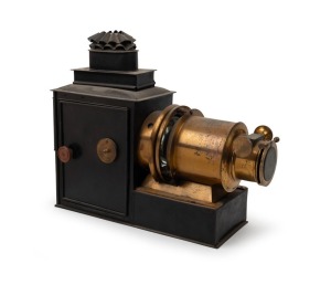 Brass and tin helioscopic magic lantern, c. 1890s, with 7" lens and engraving on lens flap that reads 'Established 1816 - Trade Mark - London Made'. Modified for electric use.