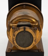 Brass and tin helioscopic&nbsp;magic lantern, c. 1890s, with 7" lens and engraving on lens flap that reads 'Established 1816 - Trade Mark - London Made'. Modified for electric use. - 3