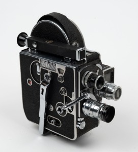 BOLEX-PAILLARD: H8S double-8 movie camera, c. 1947, with three lenses, one lens cap, viewfinder attachment, and eye cup.