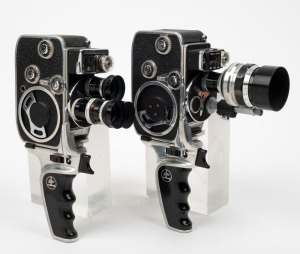 BOLEX-PAILLARD: Two c. 1958 double-8 movie cameras, both with pistol-grip attachments - one D8L [#814002] with Bolex-Anamorphot 8/19/1,5x attachment and lens hood, and one D8LA [#854292] with three lens hoods. (2 movie cameras)