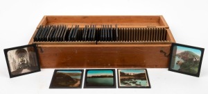 Wooden box containing thirty-one 8 x 8cm glass slides featuring colourised photographs of cities and coastal features in Devon and Cornwall. (31 items)