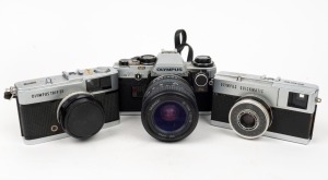 OLYMPUS: Group of three cameras - one c. 1960s Olympus Trip 35 with lens cap and wrist strap, one c. 1960s Olympus Quickmatic, and one Olympus OM10 with neck strap. (3 cameras)