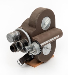 BELL & HOWELL: Bell & Howell 70DR 16mm movie camera, c. 1940s, with three lenses, three viewfinders, and one lens cap.