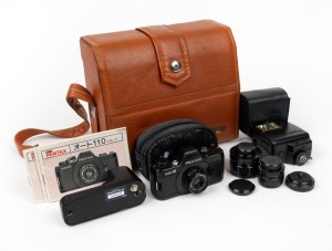 ASAHI KOGAKU: Pentax Auto 110 miniature SLR camera, c. 1979, in matching leather box with three lenses, 110 Winder attachment, AF130P flash attachment, five lens caps, two leather cases, and printed matter.