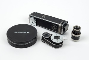 BOLEX-PAILLARD: Group of four accessories - one Aspheron 4mm Super Wide Angle teleconverter in case, one Octameter viewfinder, one Bolex Proxidirect, and one Yvar AR 36mm f2.8 lens. (4 items)