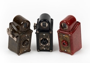 CORONET: Three c. 1935 Midget subminiature Bakelite cameras - one in red, one in dark green, and one in black. (3 cameras)