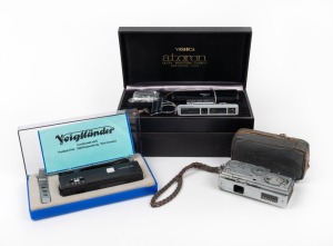 VARIOUS MANUFACTURERS: Group of three subminiature cameras - one c. 1959 Mamiya-16 Automatic in leather case, one c. 1965 Yashica Atoron outfit in box with several accessories, and one Voigtländer Vitoret 110 in case with accessories. (3 cameras)