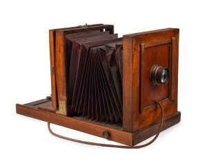 Large 5 x 7" plate tailboard camera, with Kodak Eastman brass lens, integrated rubber shutter release cable, and tray length of 69.5cm.