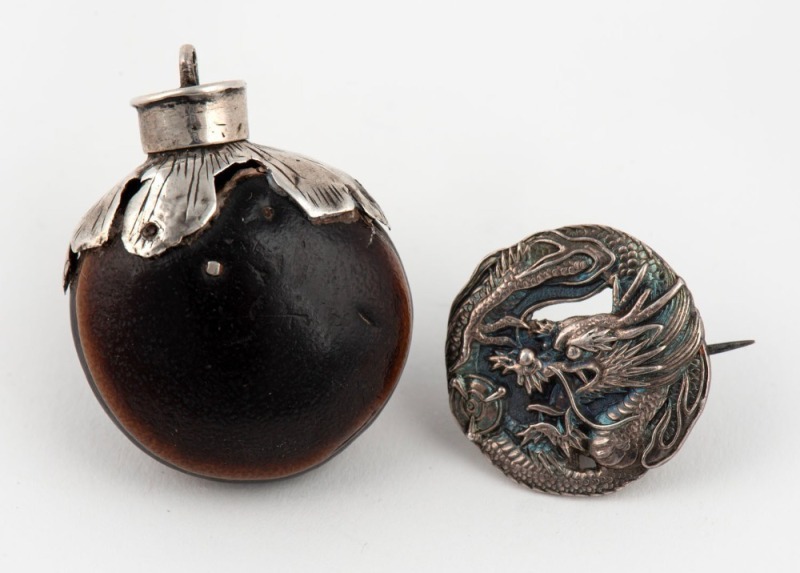 A Chinese silver dragon brooch and a silver mounted seed pod bottle pendant, (2 items), the largest 4cm high