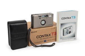 YASHICA: Titanium-body Contax T3 compact camera [#065301], c. 2001, with Carl Zeiss Sonnar T 35mm f2.8 lens. Offered in maker's box with leather case, wrist strap, and printed materials.