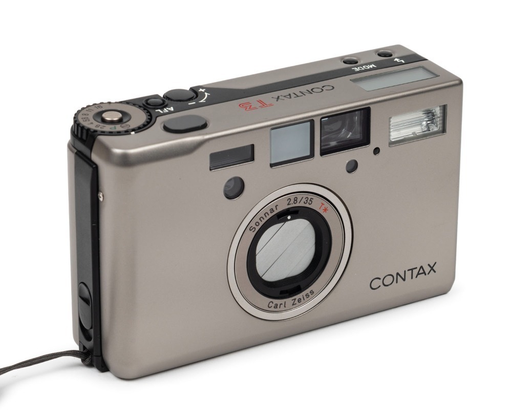 YASHICA: Titanium-body Contax T3 compact camera [#065301], c. 2001, with Carl  Zeiss Sonnar T 35mm f2.8 lens. Offered in maker's box with leather case,  wrist strap, and printed materials.