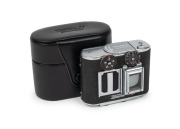 CONCAVA: Black-body Tessina&nbsp;35 subminiature camera [#166853], c. 1970s, with Tessinon 25mm f2.8 lens, together with matching black leather case.