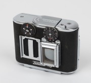 CONCAVA: Black-body Tessina&nbsp;35 subminiature camera [#166853], c. 1970s, with Tessinon 25mm f2.8 lens, together with matching black leather case. - 2