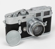 LEITZ: Leica M3 rangefinder camera [#952 529], c. 1959, with Summar 50mm f2 lens [#316606]. Later iteration with single-stroke film advance mechanism. Metal lens cap and brown leather case with strap also present. - 2