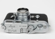 LEITZ: Leica M3 rangefinder camera [#952 529], c. 1959, with Summar 50mm f2 lens [#316606]. Later iteration with single-stroke film advance mechanism. Metal lens cap and brown leather case with strap also present. - 3