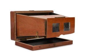 Folding handheld polished mahogany stereoscope, c. 1910s, of French manufacture with 'N H Brevette S.G.D.G.' imprint on top element.