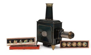 ERNST PLANK: Children's magic lantern, height 23.5cm, in maker's box with nine glass slides, c. 1890s.